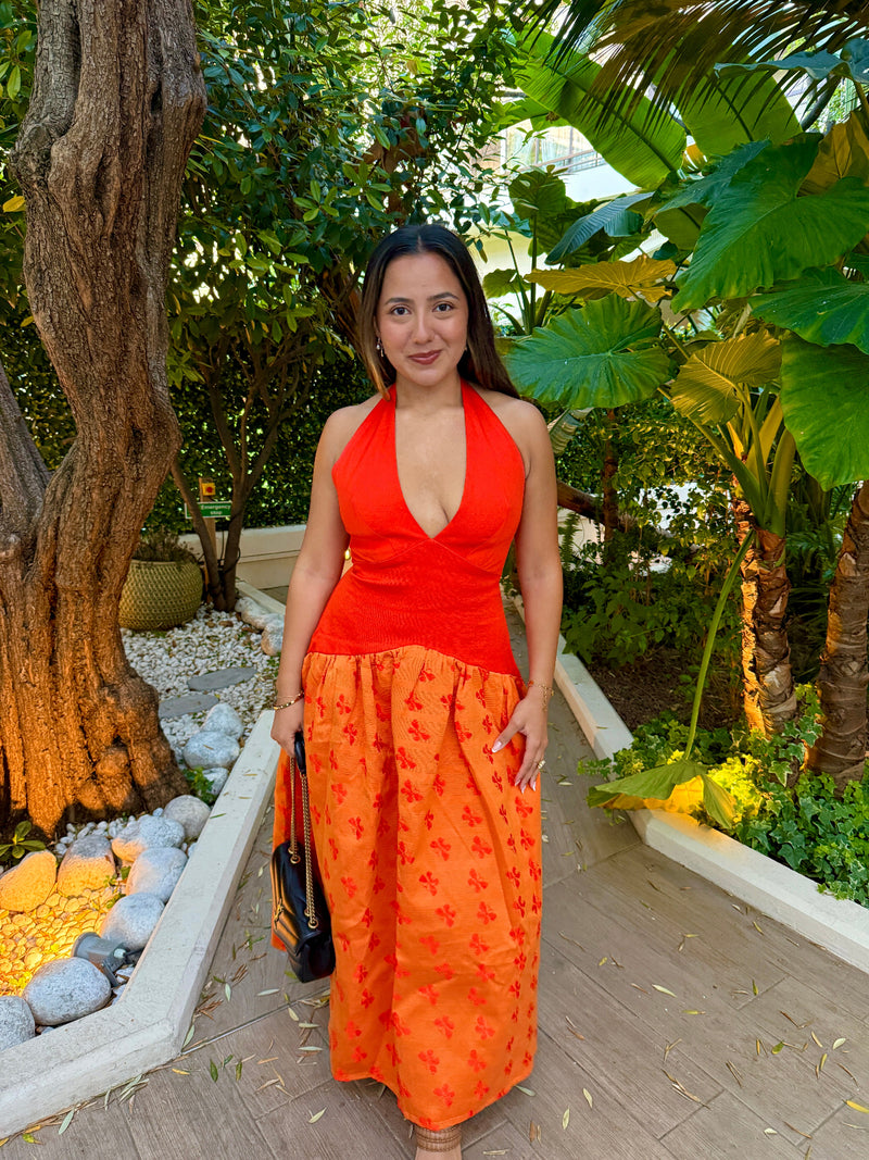 Woman in an Mariposa dress standing in a garden setting